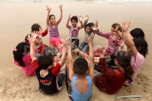 1364847107-palestinian-children-play-on-the-beach-in-gaza-city_1926722
